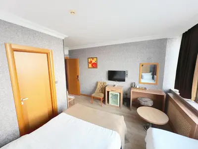 a hotel room with a bed and a tv at Lounge Hotel in Tuzla