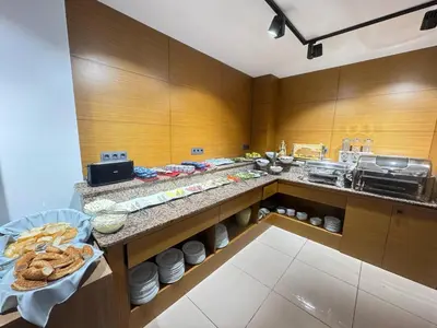 a kitchen with a counter with food on it at Lounge Hotel in Tuzla