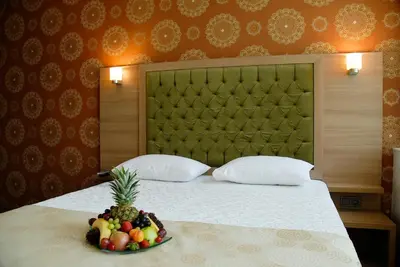 a bedroom with a bed with a bowl of fruit on it at Lounge Hotel in Tuzla