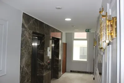 a hallway with a walk in shower and a glass wall at Quars Suite in Esenyurt