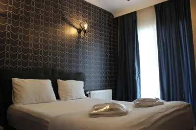 a bedroom with a bed with two towels on it at Quars Suite in Esenyurt