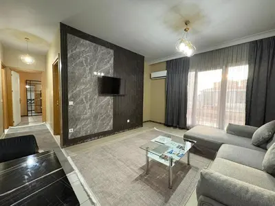 a living room with a couch and a tv at Quars Suite in Esenyurt