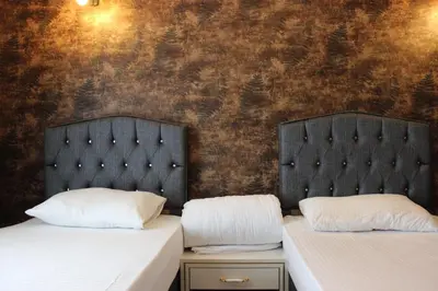 two beds sitting next to each other in a room at Quars Suite in Esenyurt