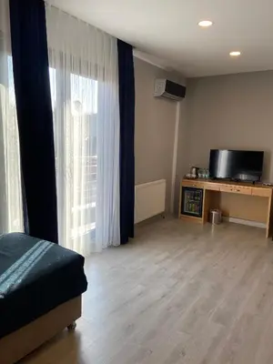 a room with a bed and a tv and a window at Liberi Hotel Taksim in Istanbul