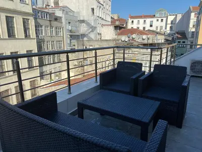 two chairs and a table on top of a balcony at Liberi Hotel Taksim in Istanbul