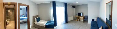 a room with a bedroom with a bed and a mirror at Liberi Hotel Taksim in Istanbul