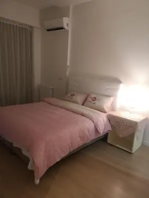 a bedroom with a bed with a pink blanket and a table at Have a nice holiday in Istanbul