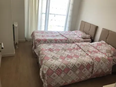 a bedroom with two beds and a window at Have a nice holiday in Istanbul