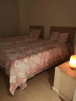 a bedroom with a bed with a red and white comforter at Have a nice holiday in Istanbul