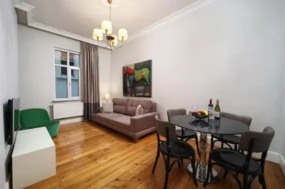 a living room with a table and chairs and a couch at Meroddi Galata Flats in Istanbul