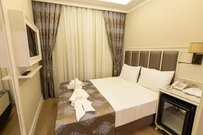 a hotel room with a bed and a phone at Villa Sweet Hotel in Istanbul