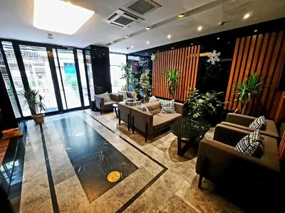 a lobby with couches and plants in a building at Pell Palace Hotel & SPA in Istanbul