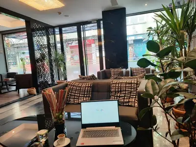 a laptop computer sitting on a table in a restaurant at Pell Palace Hotel & SPA in Istanbul