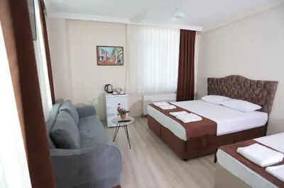 a hotel room with a bed and a couch at BEKSİTİ HOTEL in Yalova