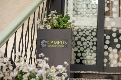 a sign for campus on a staircase with flowers at Campus Boutique Hotel in Istanbul