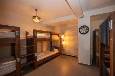 a room with bunk beds and a clock on a wall at Taksim Square Hostel in Istanbul