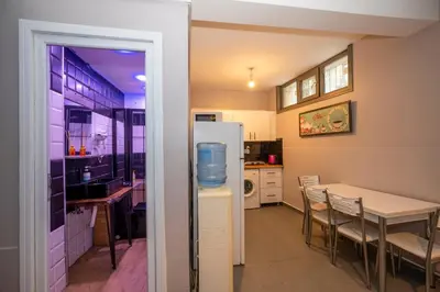 a kitchen and dining room with a table and a refrigerator at Taksim Square Hostel in Istanbul