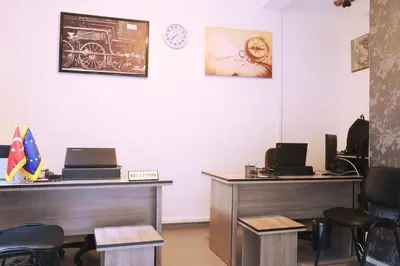 a waiting room with two desks and a clock on the wall at Taksim Square Hostel in Istanbul