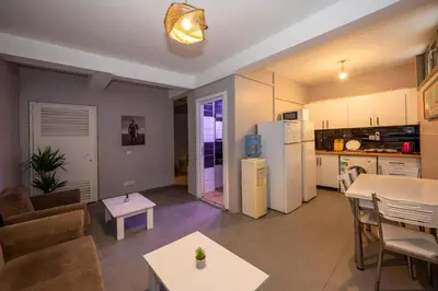 a kitchen and a living room with a table at Taksim Square Hostel in Istanbul