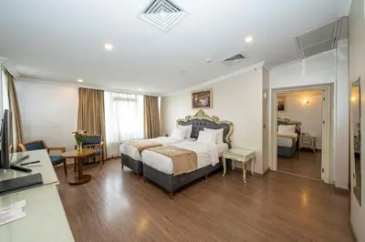 a hotel room with a bed and a living room at Almadina Hotel Istanbul in Istanbul
