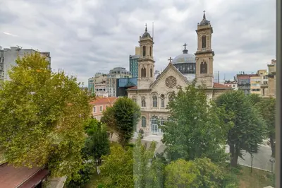 an old building with two towers in a city at Almadina Hotel Istanbul in Istanbul