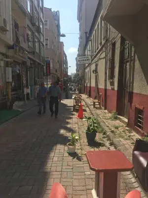 an empty street with people walking down the street at Çatı Apartment in Istanbul