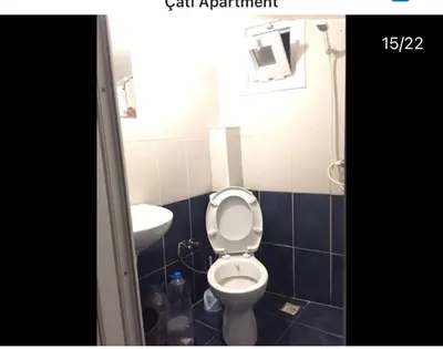 a bathroom with a toilet and a sink at Çatı Apartment in Istanbul