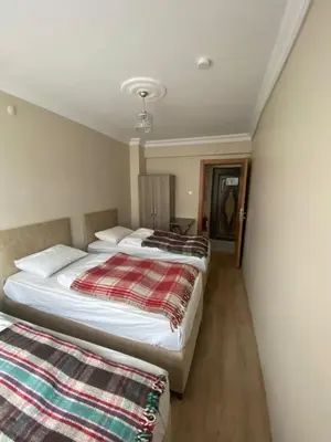 two beds in a hotel room with two at Yakup's Apartment in Istanbul