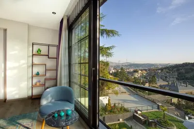 a room with a window with a chair and a view at DM Suites Bosphorus in Istanbul