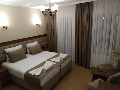 a bedroom with a large bed with towels on it at Ribad Hotel Sultanahmet in Istanbul