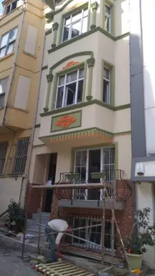 a man is working on the front of a building at The White Swan Suites Beyoglu in Istanbul