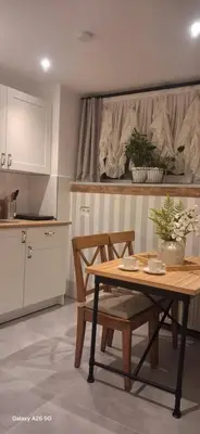 a kitchen with a wooden table and two chairs at The White Swan Suites Beyoglu in Istanbul