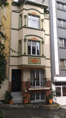 a tall building with windows and a balcony at The White Swan Suites Beyoglu in Istanbul