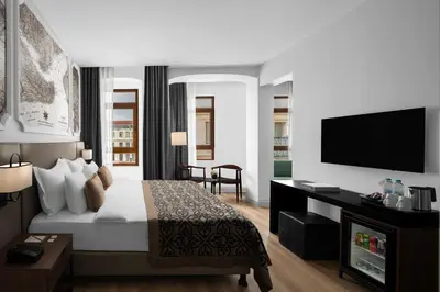 a hotel room with a bed and a flat screen tv at Akka Suites Taksim-Special Class in Istanbul