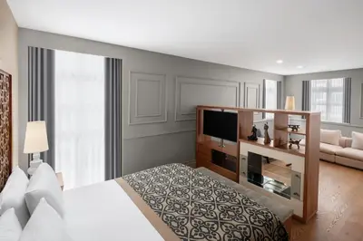 a hotel room with a bed and a television at Akka Suites Taksim-Special Class in Istanbul
