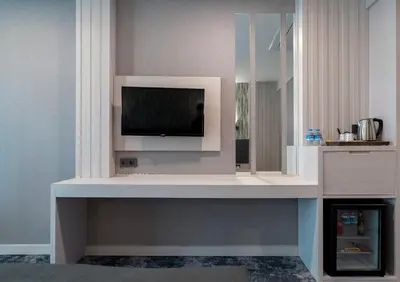 a living room with a tv on a wall at Yeşilyurt Park Otel in Corlu