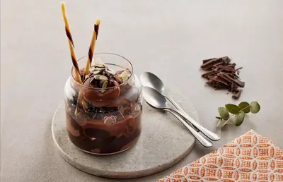 a jar of chocolate pudding on a plate with a spoon at Yeşilyurt Park Otel in Corlu