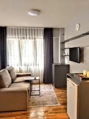 a living room with a couch in front of a window at Rodos HAN in Istanbul