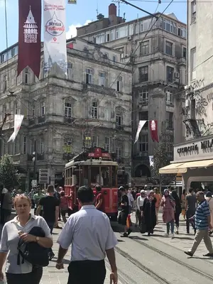 a trolley car on a busy city street with people at Rodos HAN in Istanbul