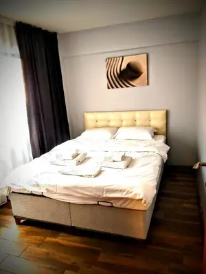 a bedroom with a large bed with white sheets at Rodos HAN in Istanbul
