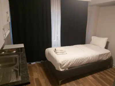 a small bedroom with a bed and a window at Rodos HAN in Istanbul