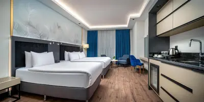 a hotel room with two beds and a kitchen at Best Western Premier Hidden Hills Hotel in Istanbul