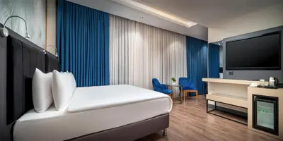 a hotel room with a bed and a tv at Best Western Premier Hidden Hills Hotel in Istanbul