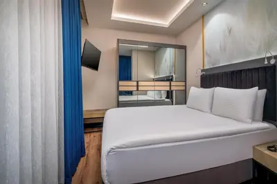 a bedroom with a large white bed and a mirror at Best Western Premier Hidden Hills Hotel in Istanbul