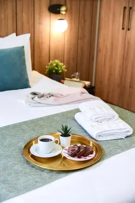 a tray with two cups of coffee and a plate of food at LUXIR HOTEL in Istanbul