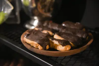a plate of chocolate covered donuts sitting on a shelf at LUXIR HOTEL in Istanbul