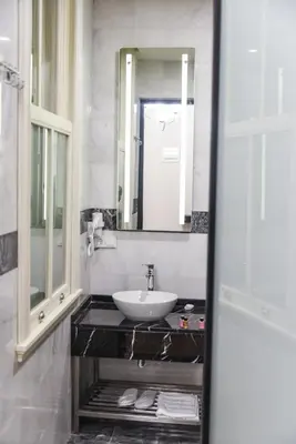 a bathroom with a sink and a mirror at LUXIR HOTEL in Istanbul