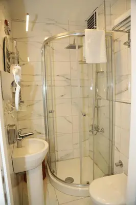 a bathroom with a shower and a toilet and a sink at Grand Kavi Hotel in Istanbul