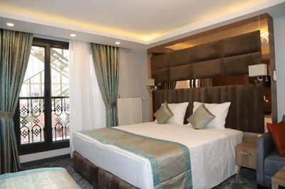 a hotel room with a bed and a balcony at Grand Kavi Hotel in Istanbul