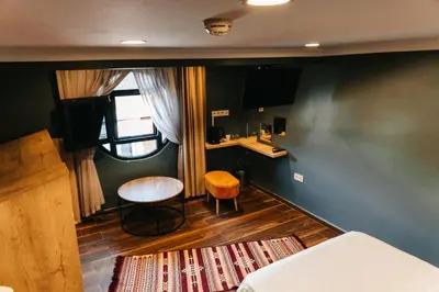a small room with a table and a stool in it at Beach Butik Hotel Şile in Istanbul